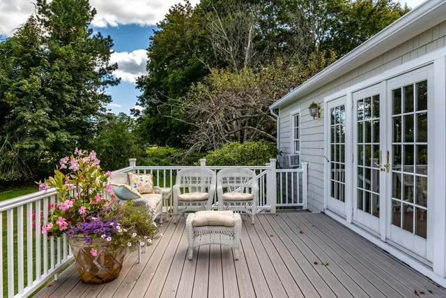 a view of balcony with seating space and wooden floor