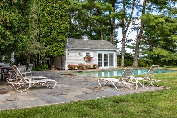 a view of a house with backyard porch and sitting area
