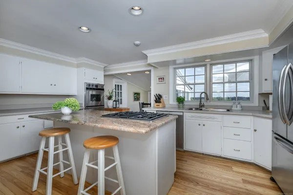 a kitchen with cabinets and chairs