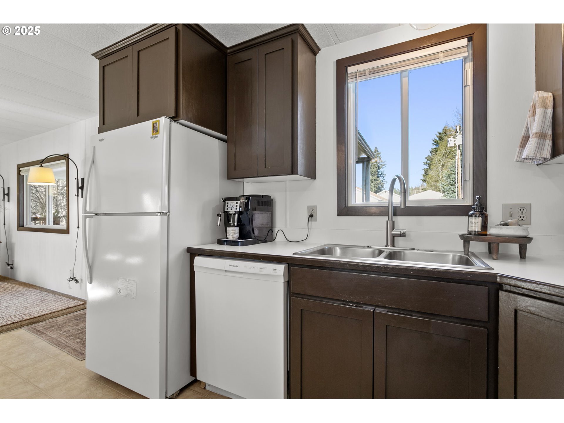 505 West Jones Street Yacolt, WA 98675 - Photo 12 of 26 a kitchen with a sink a refrigerator and cabinets