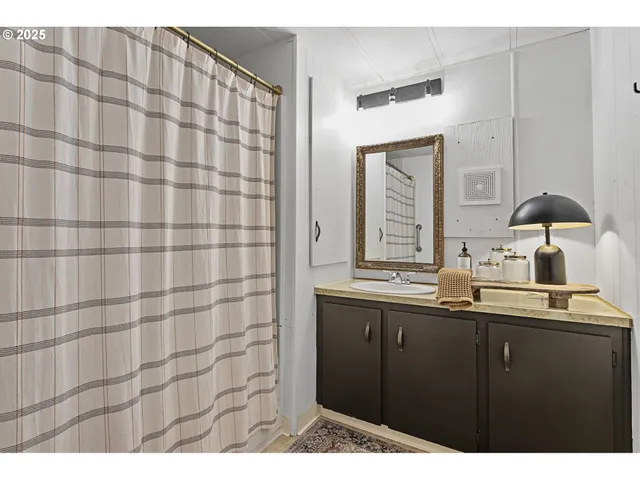 a kitchen with a sink and a mirror