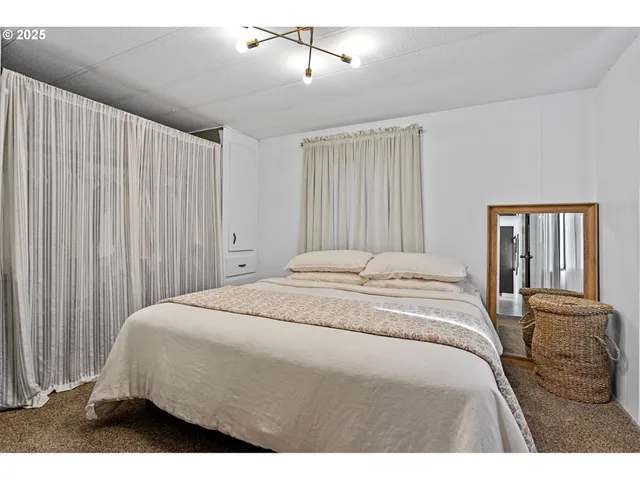 a bedroom with a bed and with furniture