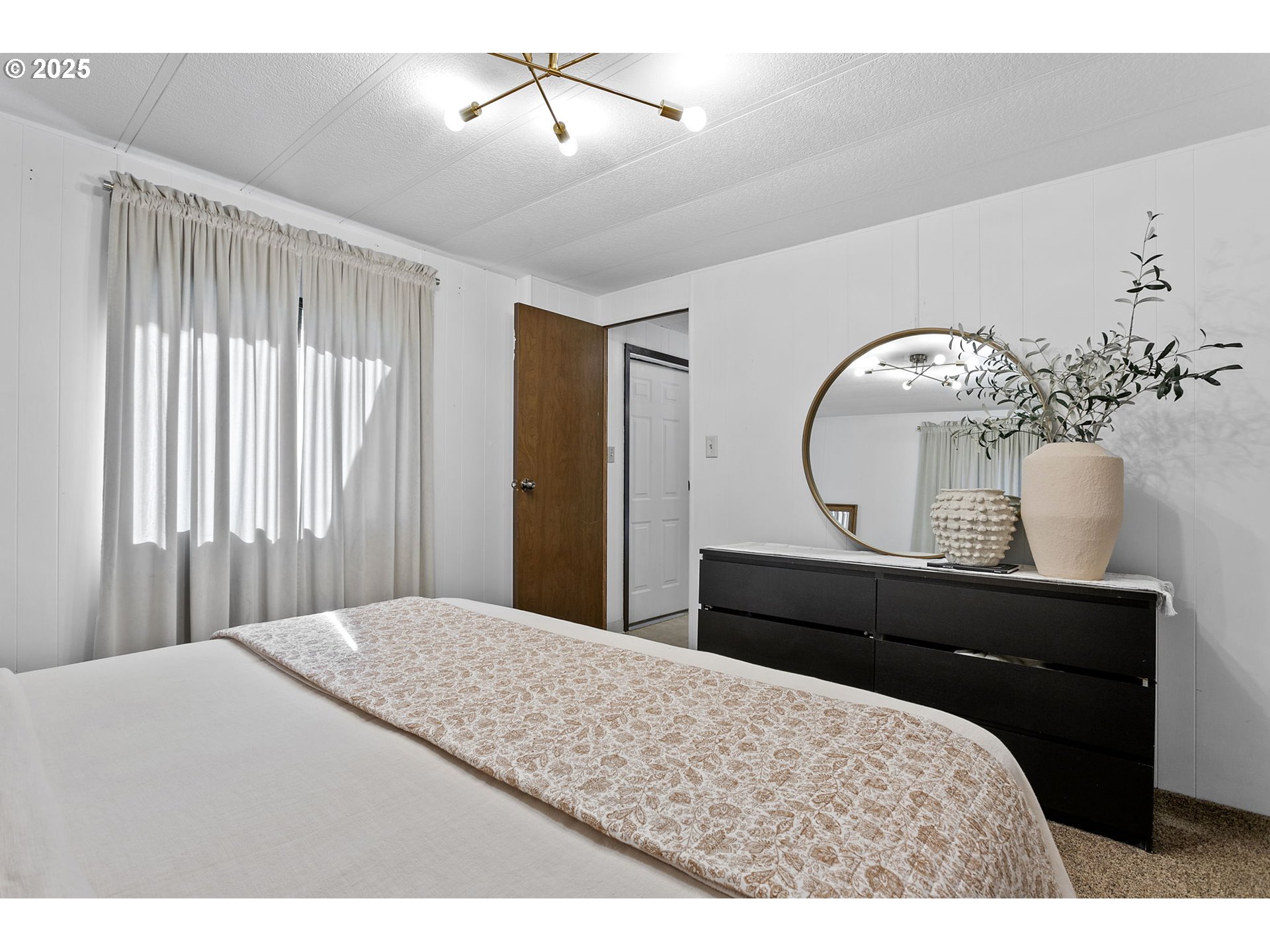 505 West Jones Street Yacolt, WA 98675 - Photo 18 of 26 a bedroom with a bed window and a chandelier