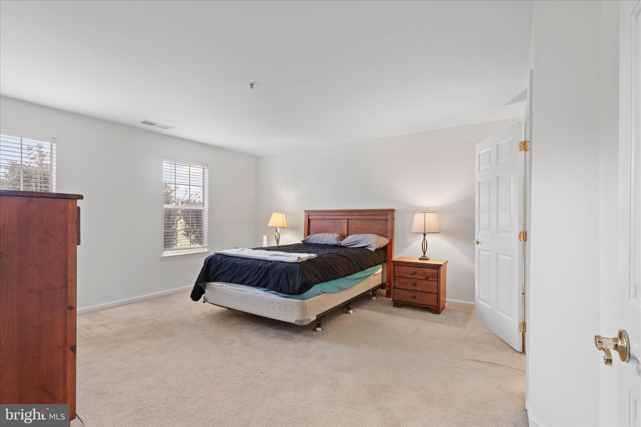 11002 Koman Circle, Unit 103 Manassas, VA 20109 - Photo 13 of 31 a bedroom with a bed and a window