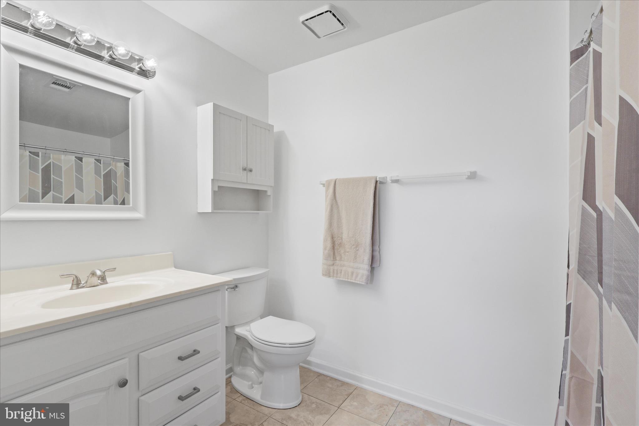 11002 Koman Circle, Unit 103 Manassas, VA 20109 - Photo 15 of 31 a bathroom with a toilet sink and mirror