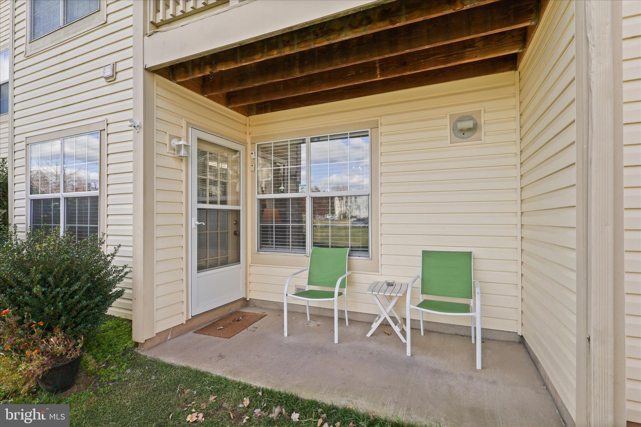 11002 Koman Circle, Unit 103 Manassas, VA 20109 - Photo 18 of 31 a view of a chair and table in backyard of the house