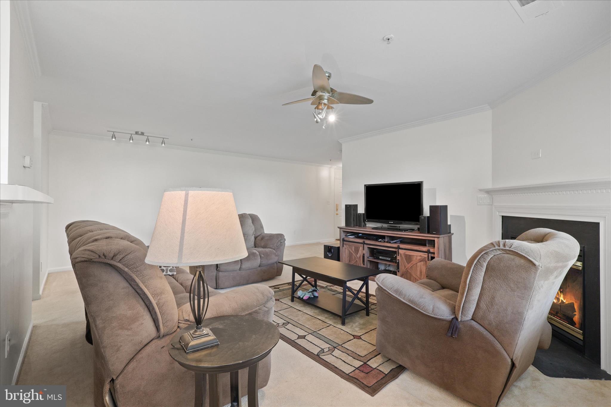 11002 Koman Circle, Unit 103 Manassas, VA 20109 - Photo 7 of 31 a living room with furniture and a flat screen tv