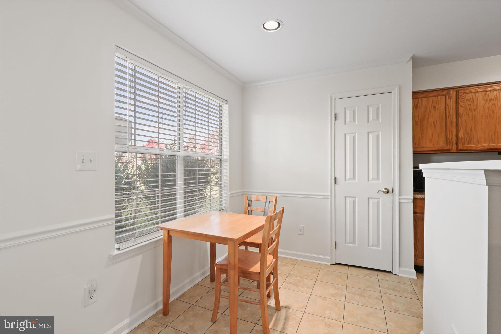 11002 Koman Circle, Unit 103 Manassas, VA 20109 - Photo 9 of 31 a view of a room that has a table and chair in it