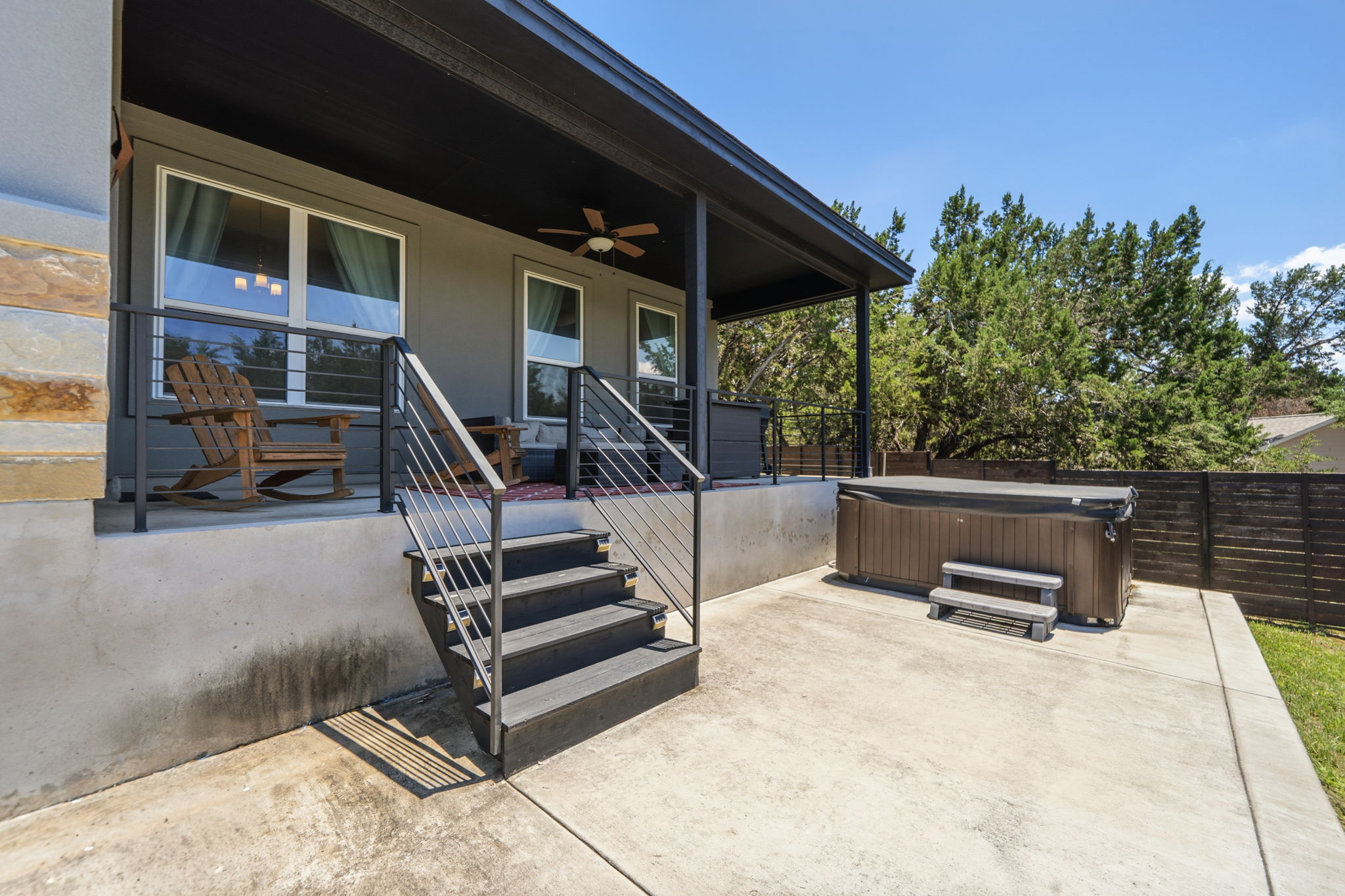 18605 Masters Cove Point Venture, TX 78645 - Photo 33 of 40 Covered patio featuring a ceiling fan, modern cable railings, and a stone facade accent