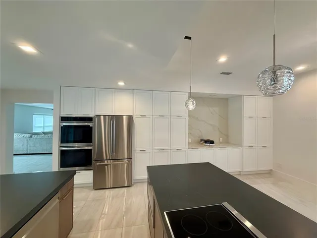 a bathroom with a sink a large mirror and a shower