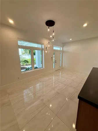 a kitchen with white cabinets and appliances