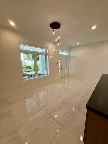 a kitchen with white cabinets and appliances