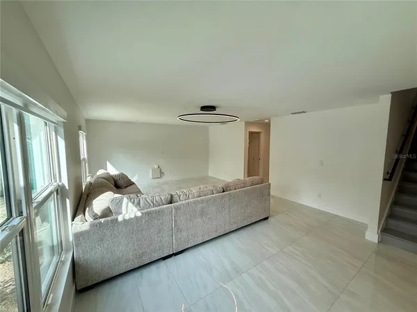 a view of living room with wooden floor and flat screen tv