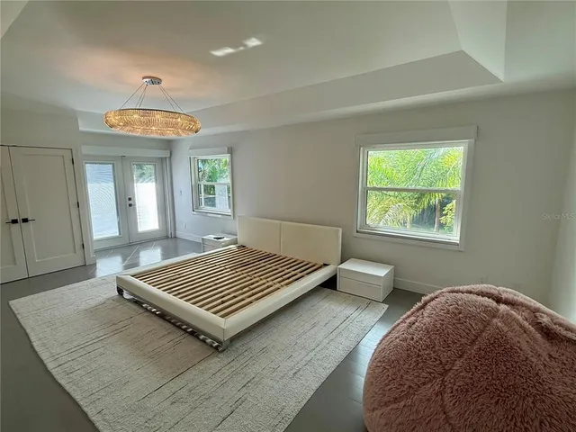 hallway with wooden floor and windows