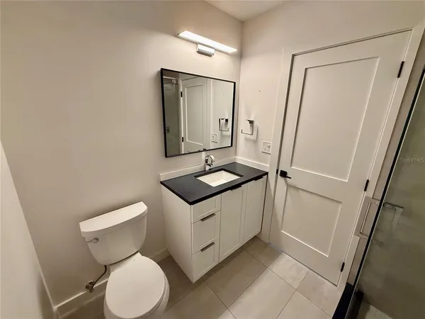 a view of a porch with furniture and floor to ceiling window
