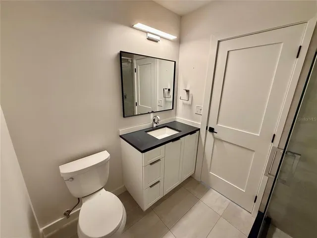 a view of a porch with furniture and floor to ceiling window