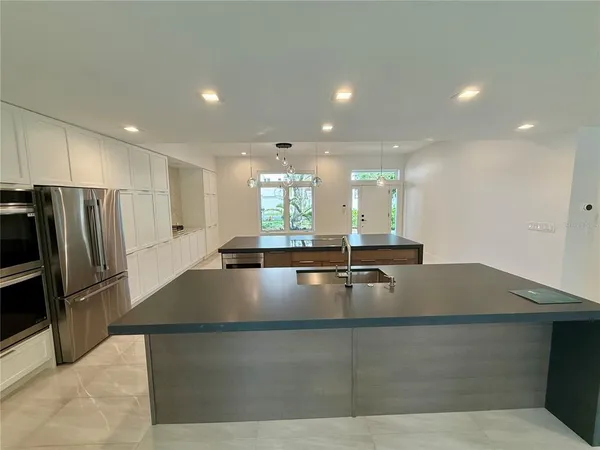a large bathroom with a large counter top and stainless steel appliances