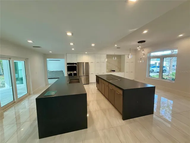 a kitchen with stainless steel appliances a refrigerator and a sink