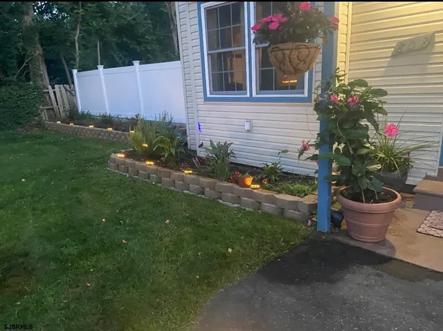 a backyard of a house with lots of green space and plants