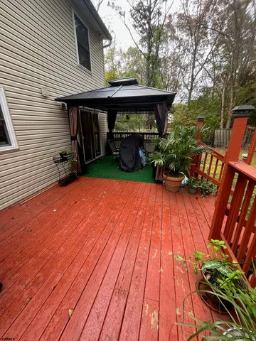 a view of a backyard with wooden fence