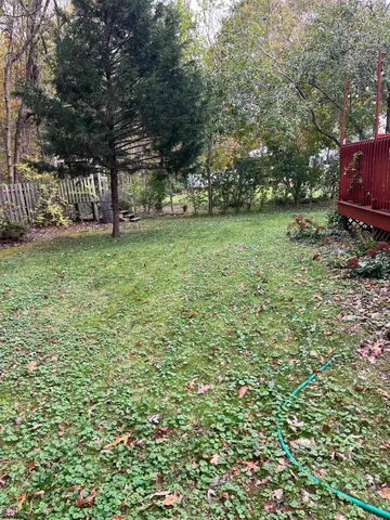a wooden bench sitting in front of a house