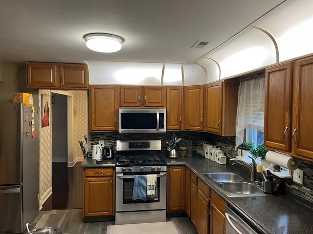 a large kitchen with cabinets and stainless steel appliances