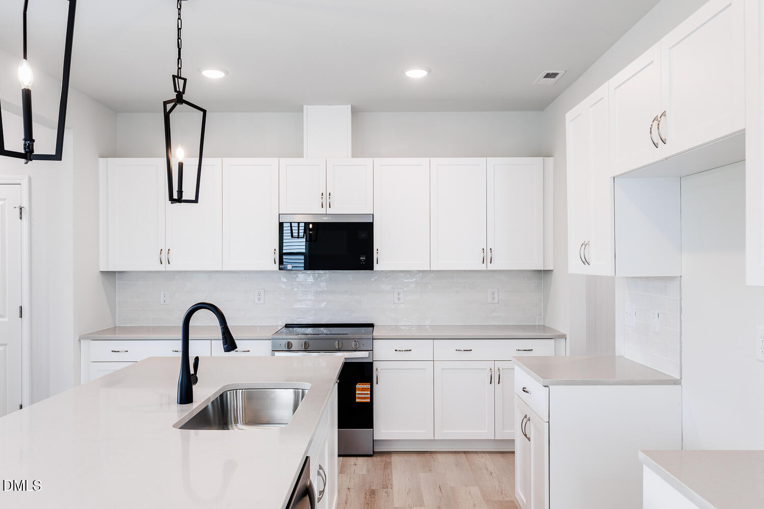 144 Siebold Street Garner, NC 27529 - Photo 13 of 40 a kitchen with white cabinets and stainless steel appliances