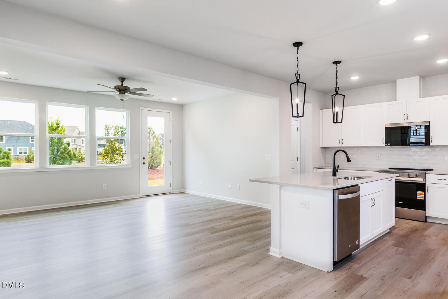 144 Siebold Street Garner, NC 27529 - Photo 21 of 40 a open kitchen with stainless steel appliances granite countertop a stove a sink dishwasher a refrigerator and a fireplace with wooden floor
