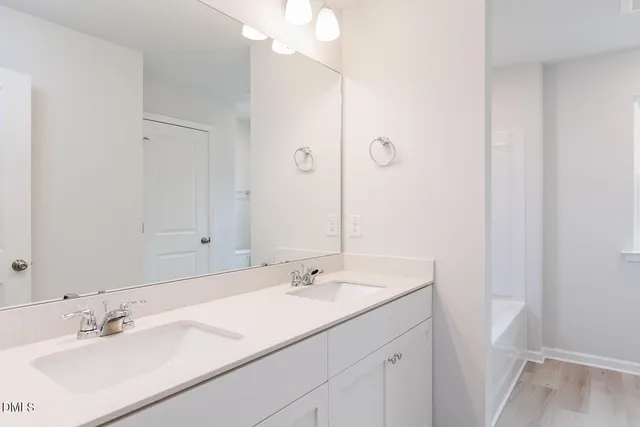 a bathroom with a tub shower and sink
