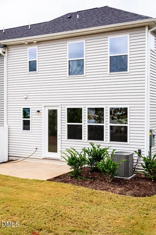 a view of a house with a yard and sitting area