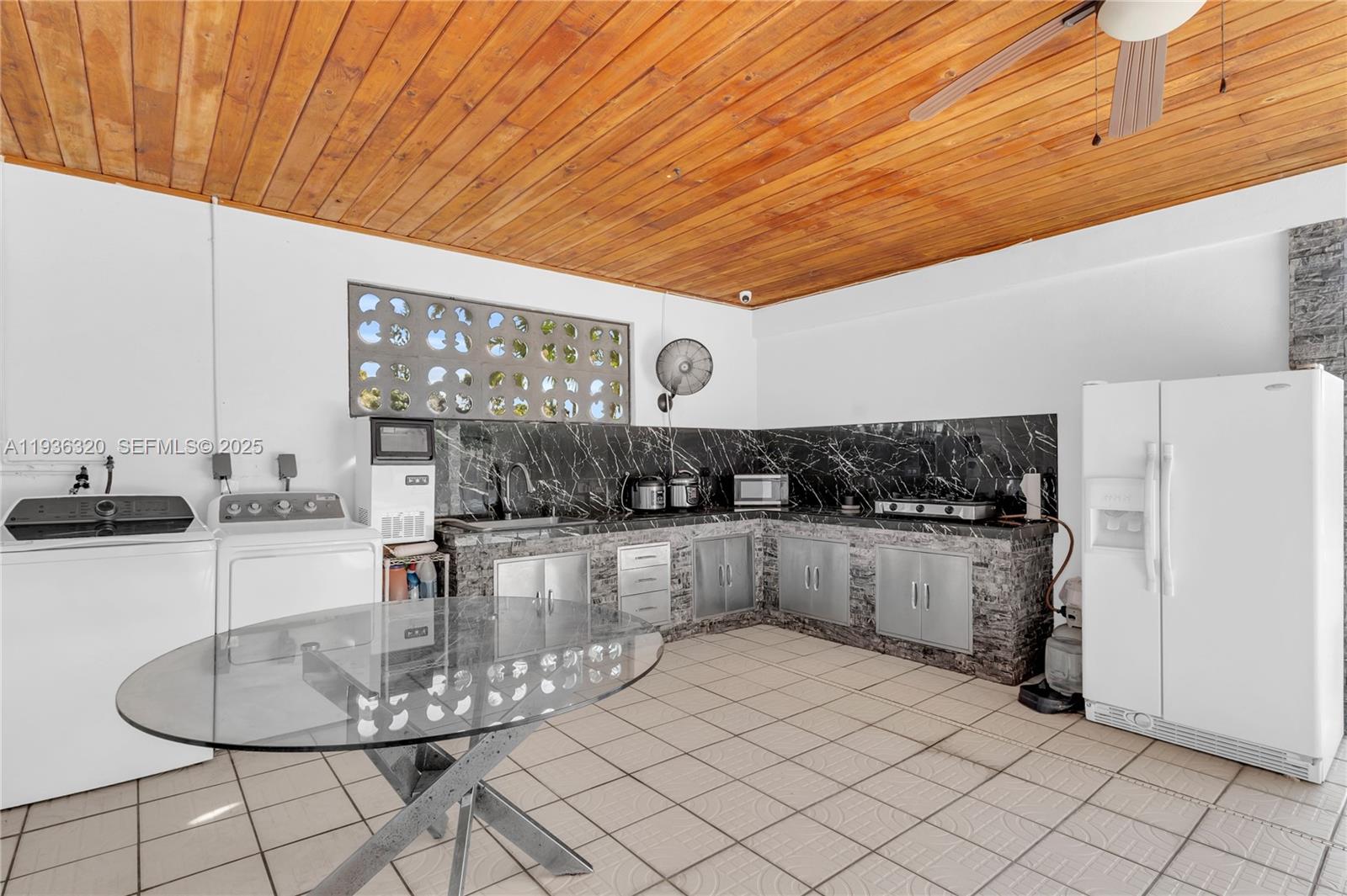 610 Northwest 16th Street Homestead, FL 33030 - Photo 15 of 27 a kitchen with stainless steel appliances kitchen island granite countertop a table chairs and granite counter tops