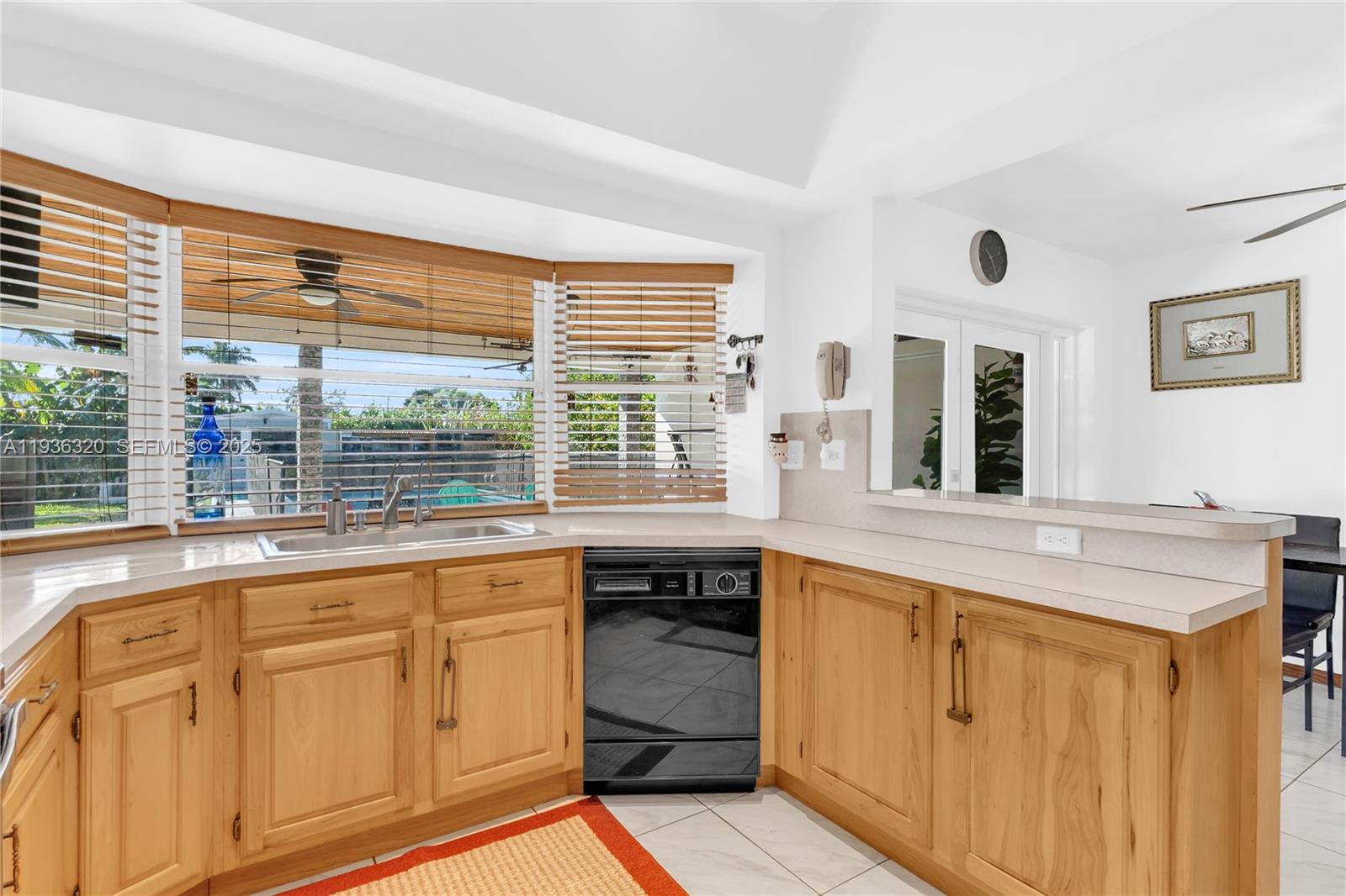 610 Northwest 16th Street Homestead, FL 33030 - Photo 9 of 27 a view of a kitchen counter top space with stainless steel appliances wooden floor and windows