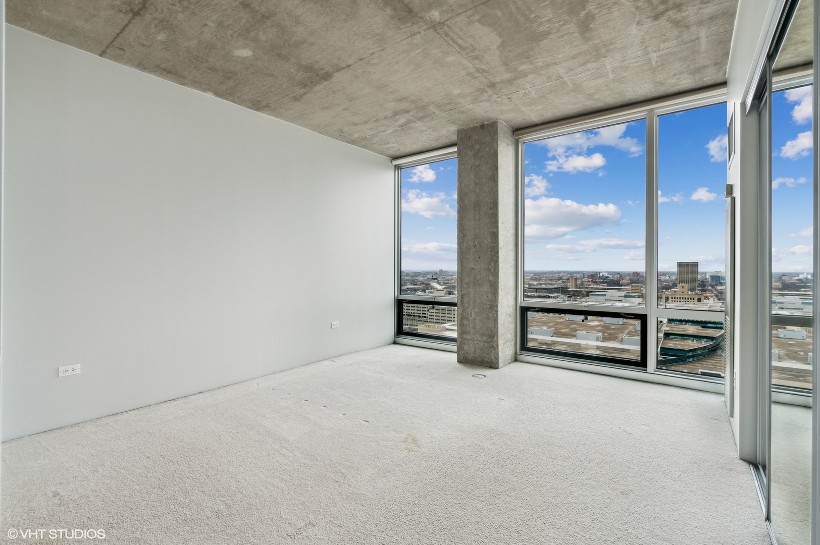 611 South Wells Street, Unit 2705 Chicago, IL 60607 - Photo 11 of 23 an empty room with floor to ceiling window and an outdoor view