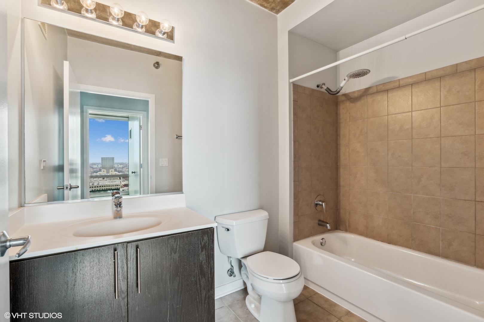 611 South Wells Street, Unit 2705 Chicago, IL 60607 - Photo 13 of 23 a bathroom with a sink a toilet and shower