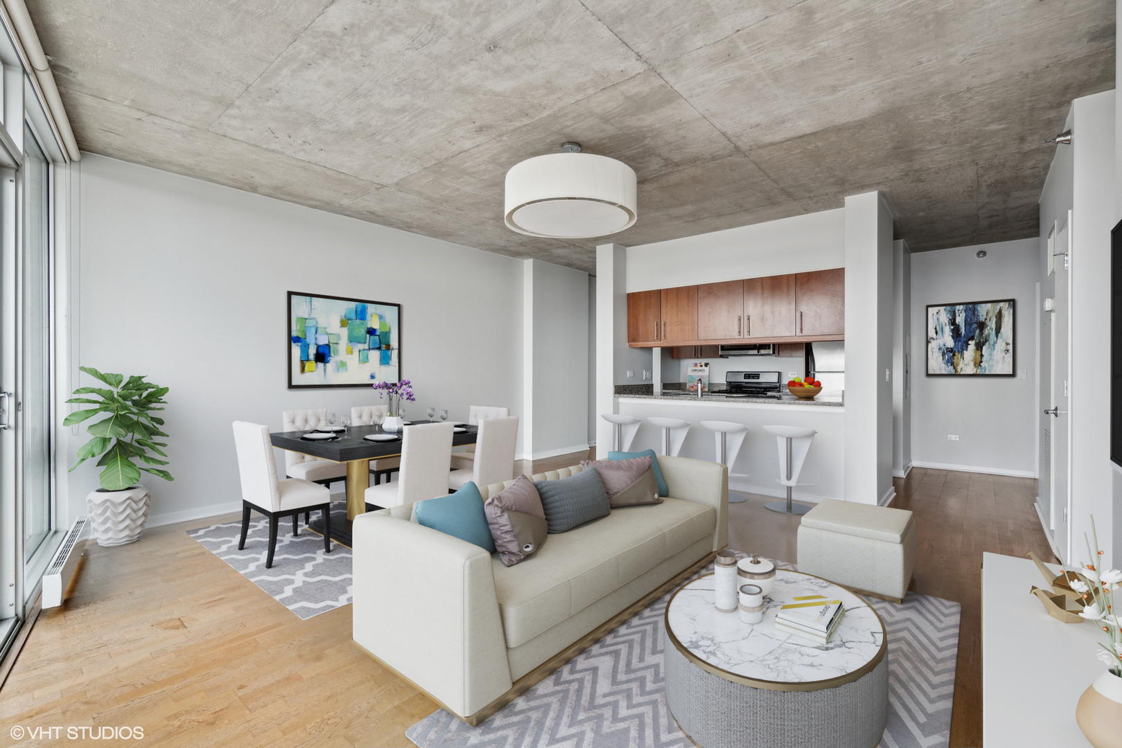 611 South Wells Street, Unit 2705 Chicago, IL 60607 - Photo 4 of 23 a living room with furniture and a dining table with potted plant