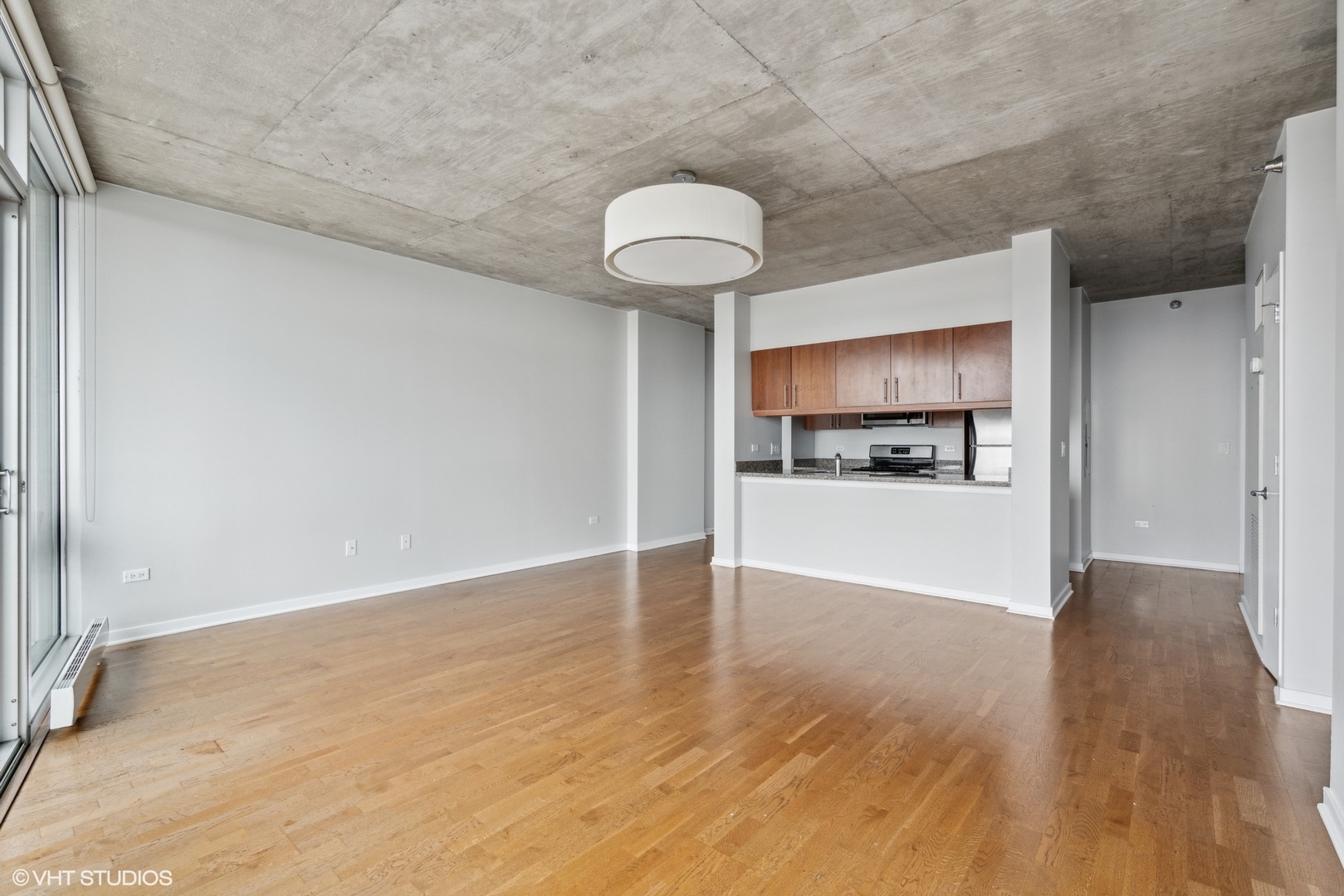611 South Wells Street, Unit 2705 Chicago, IL 60607 - Photo 5 of 23 a view of a kitchen with wooden floor and a window