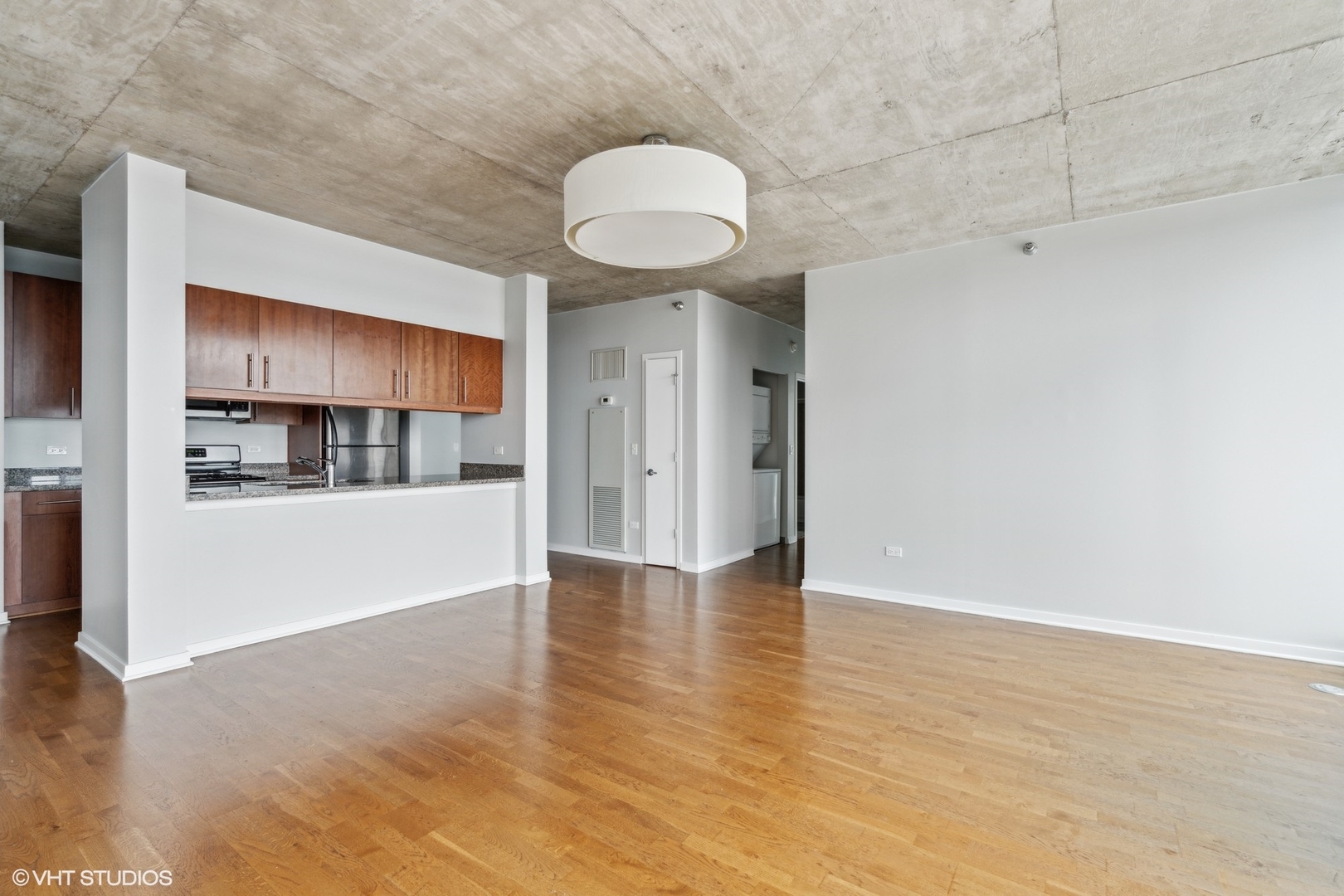 611 South Wells Street, Unit 2705 Chicago, IL 60607 - Photo 7 of 23 a view of an empty room with kitchen and a window