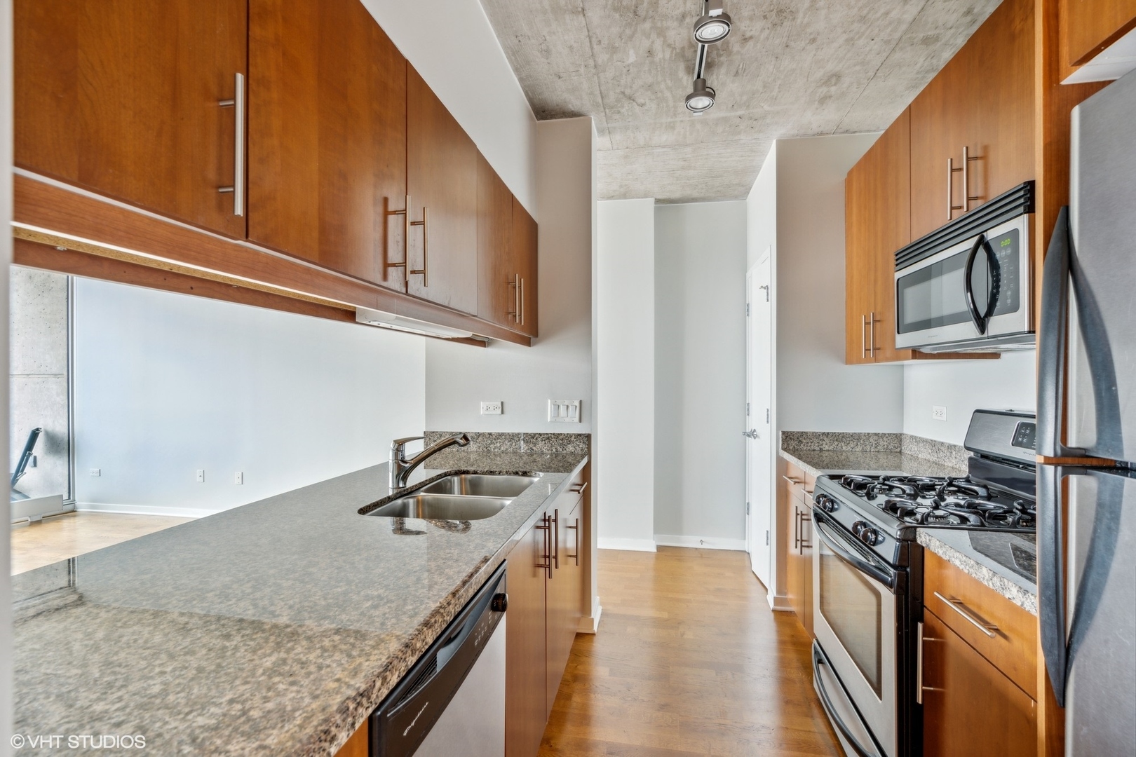 611 South Wells Street, Unit 2705 Chicago, IL 60607 - Photo 8 of 23 a kitchen with stainless steel appliances granite countertop a stove and a sink