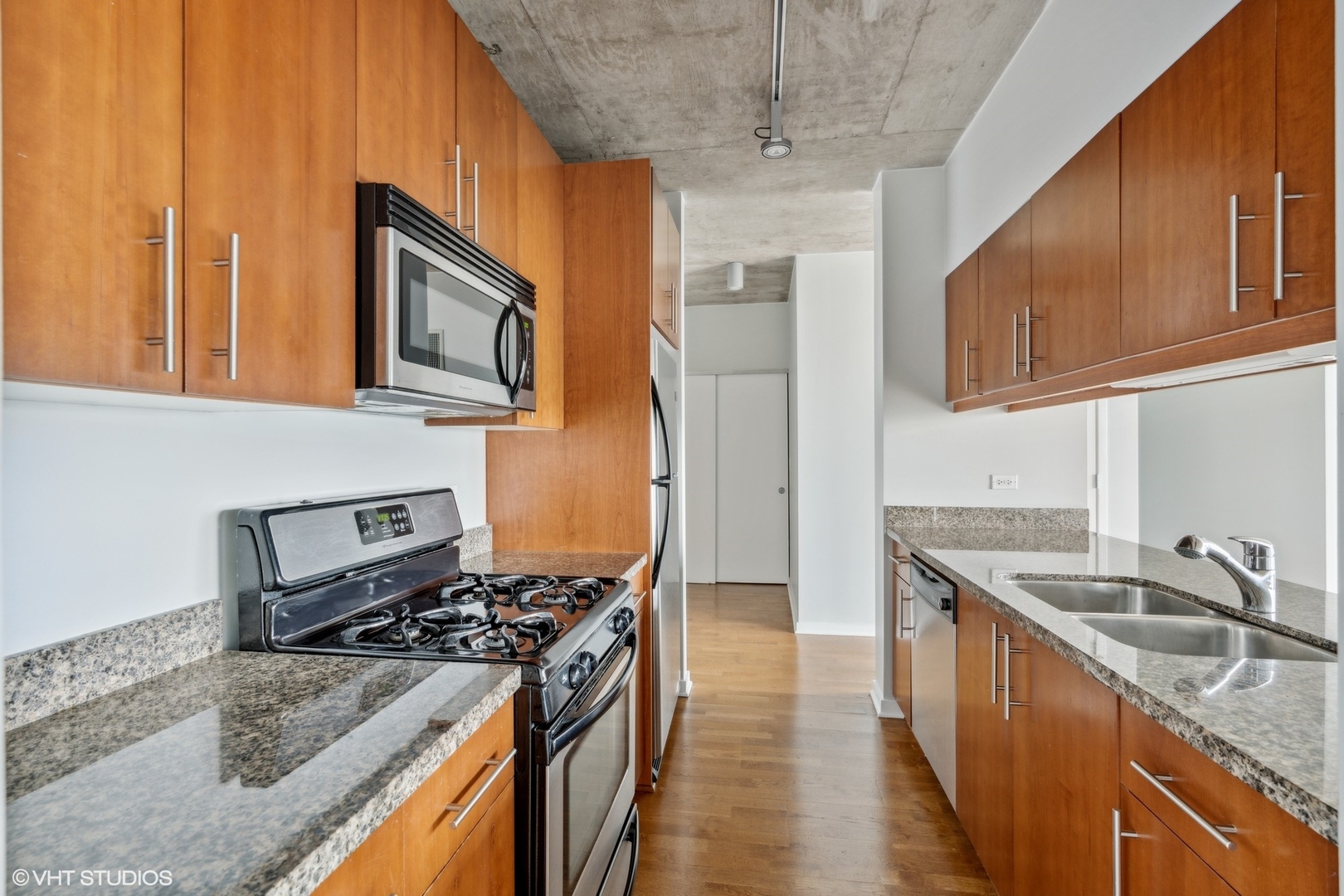 611 South Wells Street, Unit 2705 Chicago, IL 60607 - Photo 9 of 23 a kitchen with stainless steel appliances granite countertop a sink stove and refrigerator