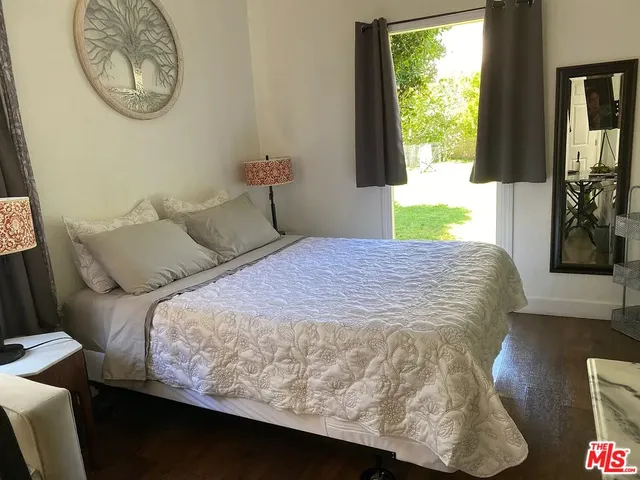 a bed sitting in a bedroom next to a window