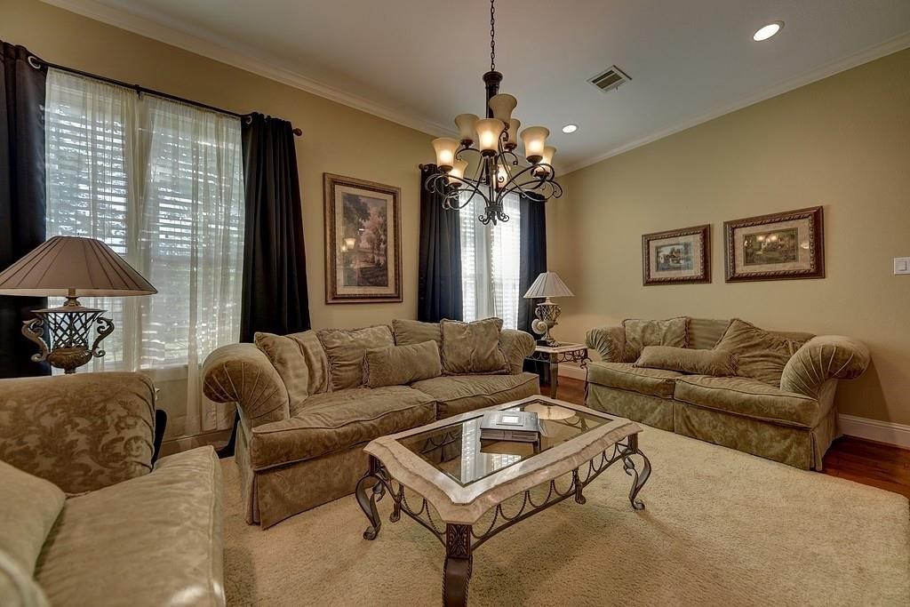 8456 Schuster Road Ledbetter, TX 78946 - Photo 17 of 49 a living room with furniture a chandelier and a window