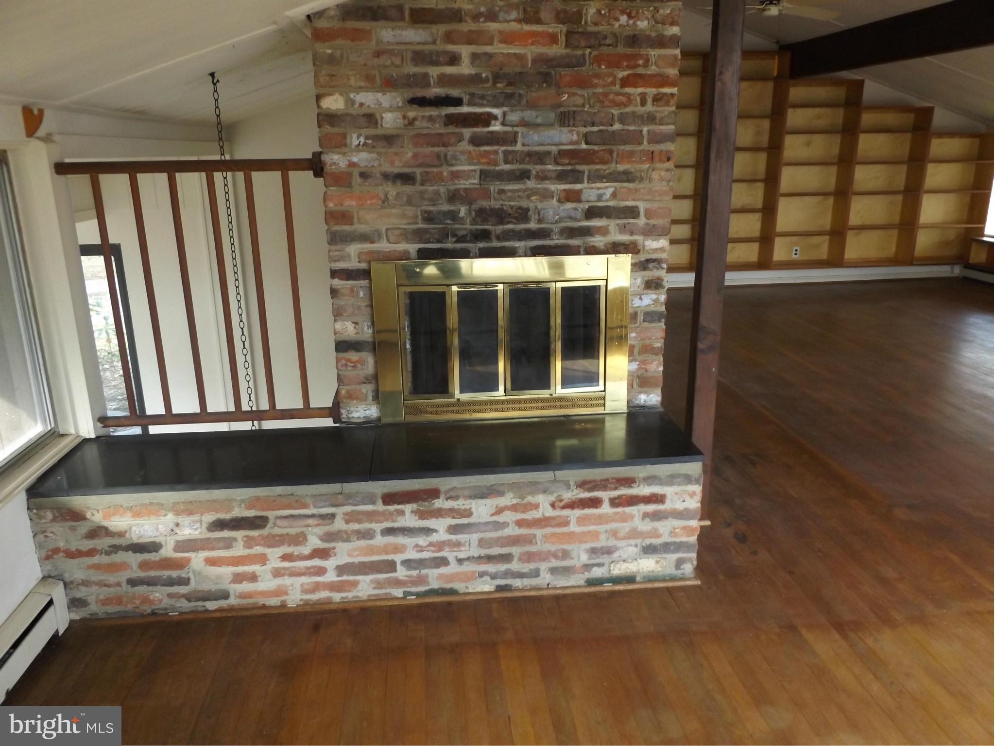857 Childs Point Road Annapolis, MD 21401 - Photo 19 of 29 fireplace and book shelves in great room