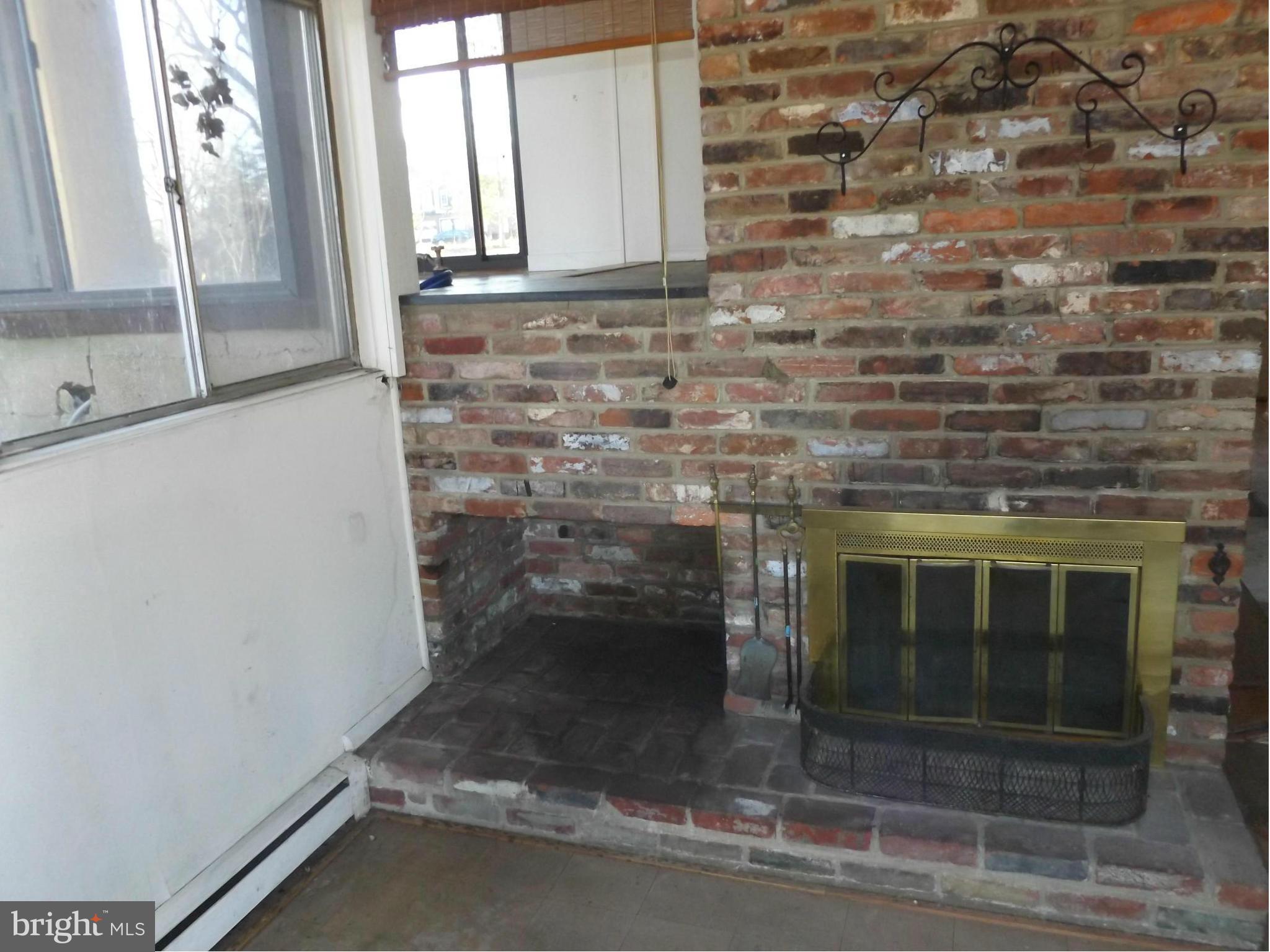 857 Childs Point Road Annapolis, MD 21401 - Photo 23 of 29 wood fireplace on lower level w/ wood store cubby