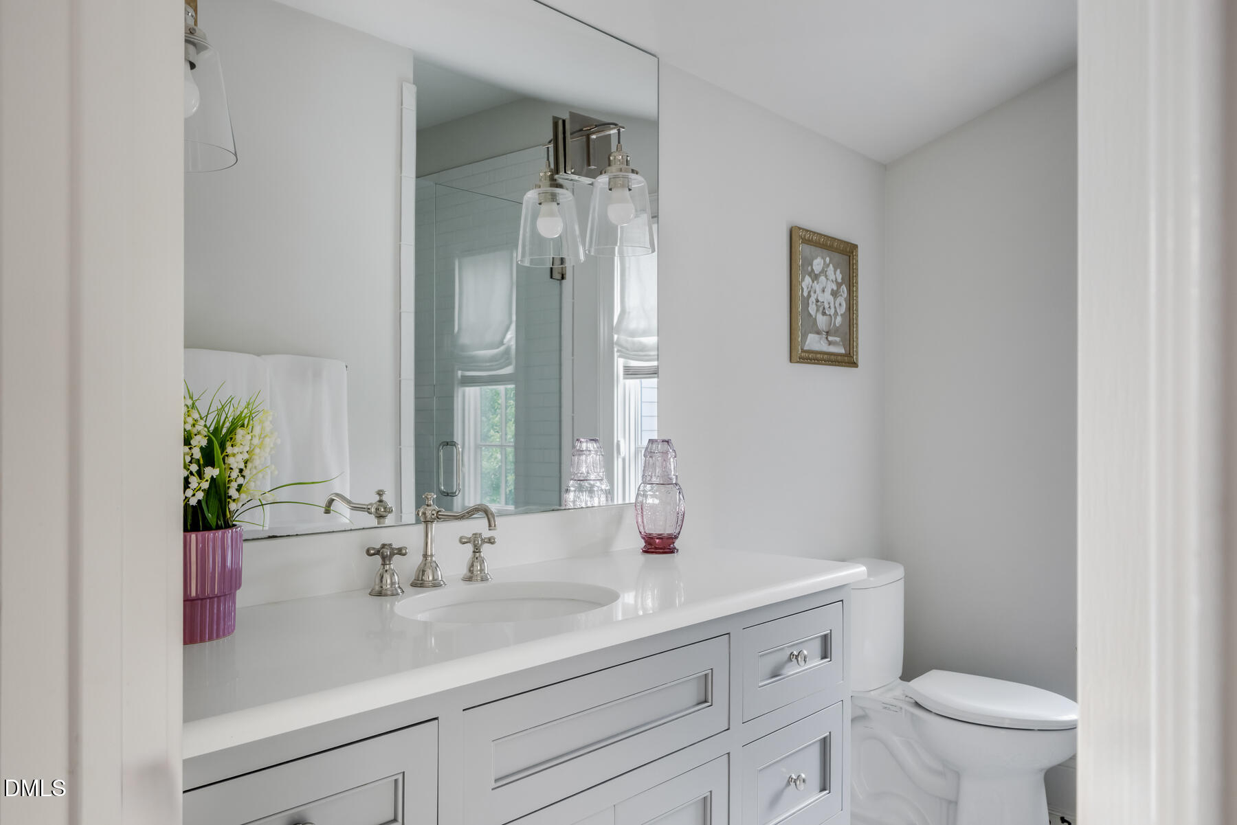 3100 Georgian Terrace Raleigh, NC 27607 - Photo 49 of 74 a bathroom with a sink a toilet and a mirror