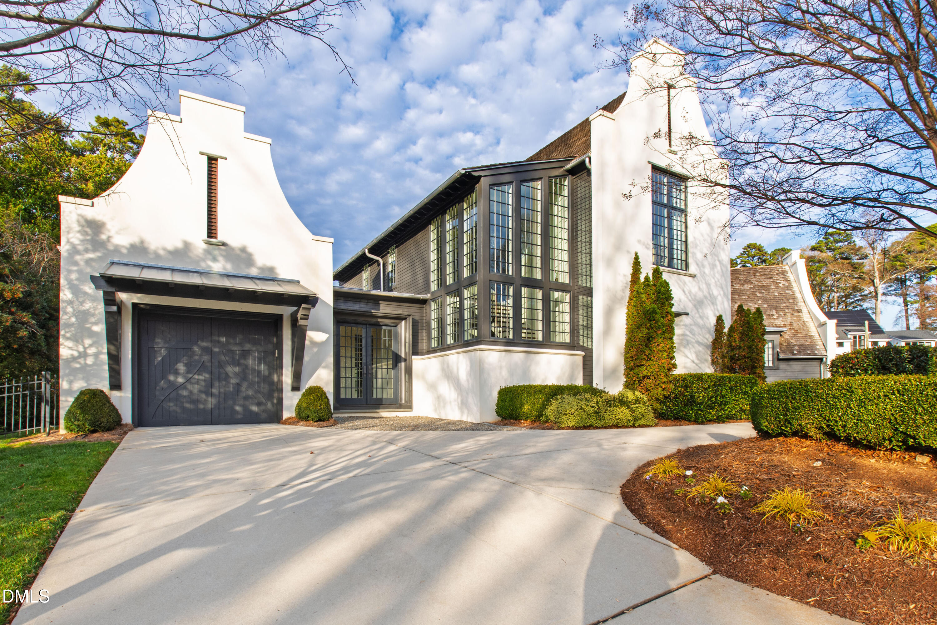 3100 Georgian Terrace Raleigh, NC 27607 - Photo 69 of 74 a view of a brick house with a small yard plants and a large tree