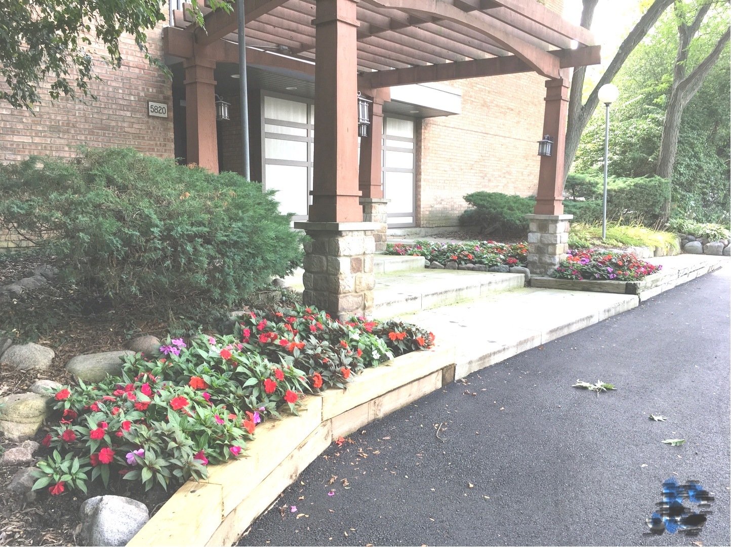 a flower garden in front of a house