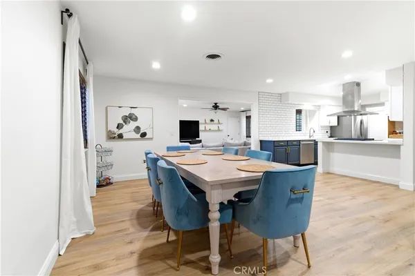 a large kitchen with a table and chairs