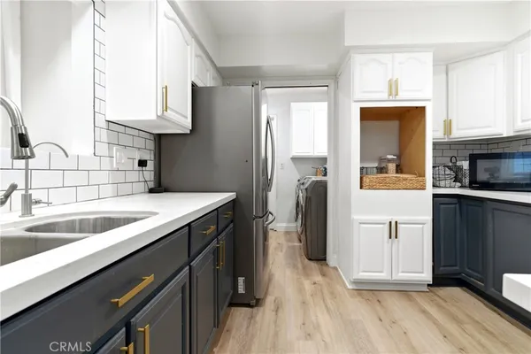 a kitchen with a sink stove and refrigerator