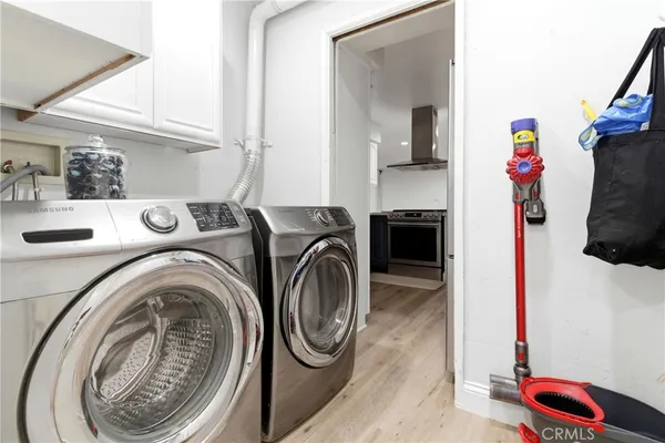 a utility room with sink dryer and washer