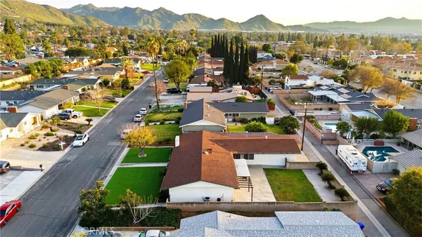 an aerial view of residential houses with outdoor space